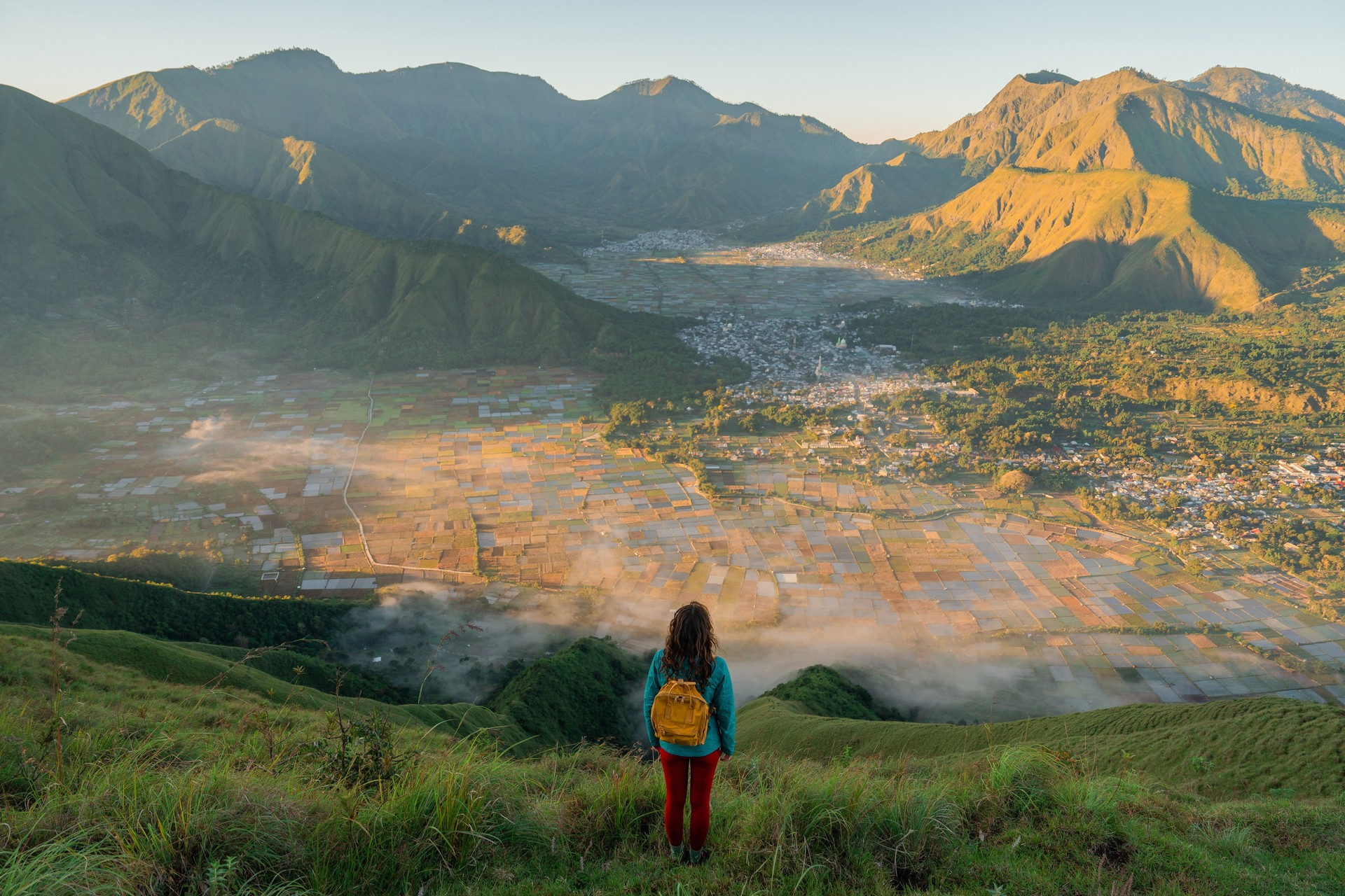 Woman standing on viewpoint after hike near mount Rinjani on Lombok